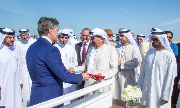Nasser Chammaa handing the first golf club to Sheikh Humaid.JPG